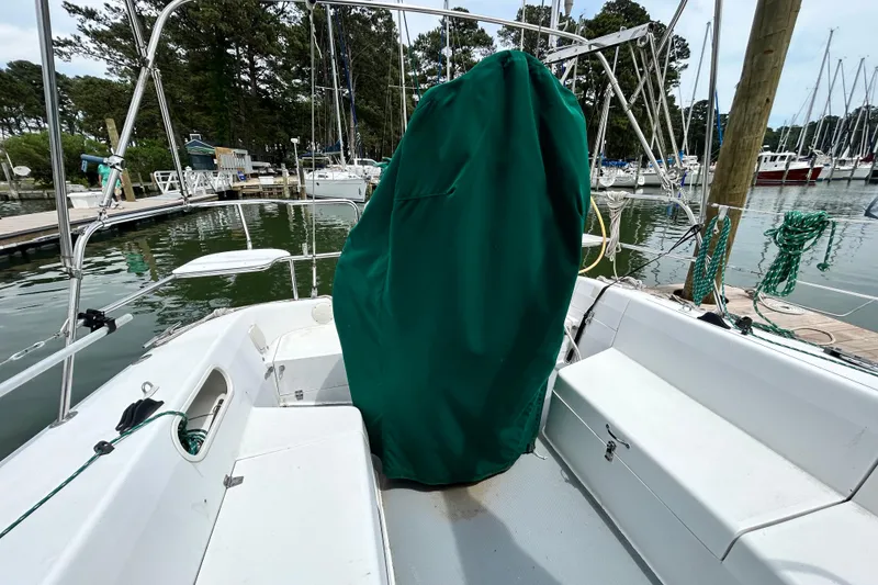 Slide: The Image of 1998 Catalina 36 MkII sailboat cockpit with green cover, docked in marina. - 14