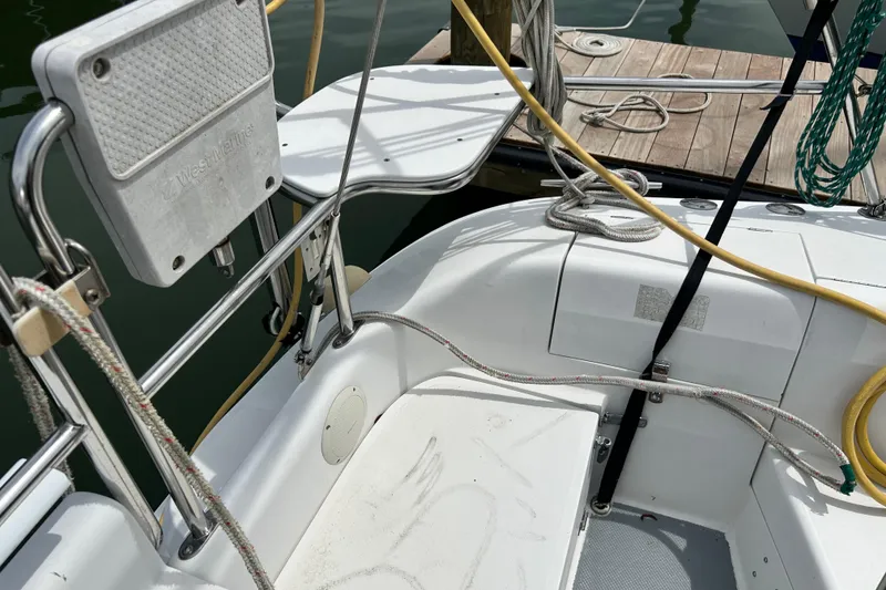 Slide: The Image of Cockpit view of a 1998 Catalina 36 MkII sailboat docked, featuring ropes and seating. - 22