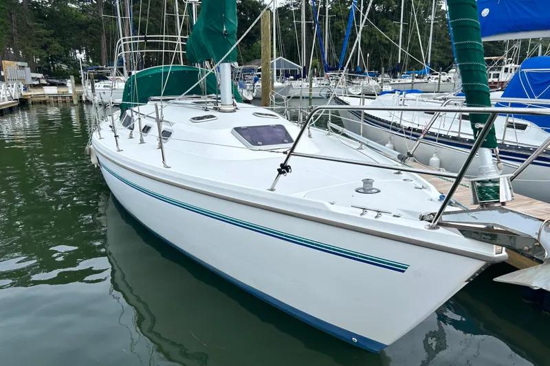 Slide: The Image of 1998 Catalina 36 MkII sailboat docked in a marina, featuring green sail covers. - 7