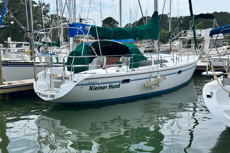 Slide: The Image of 1998 Catalina 36 MkII sailboat docked in a marina, named "Kleiner Hund." - 8