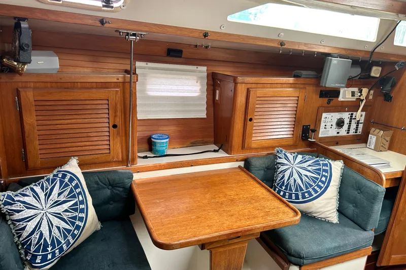 Slide: The Image of Interior of 1998 Catalina 36 MkII sailboat with wooden cabinetry and nautical-themed cushions. - 58