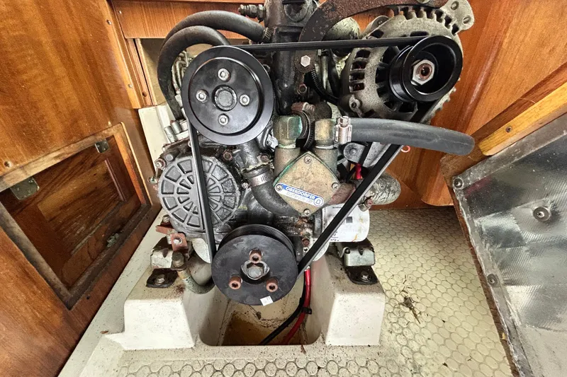 Slide: The Image of Engine compartment of a 1998 Catalina 36 MkII sailboat, showcasing mechanical components. - 35