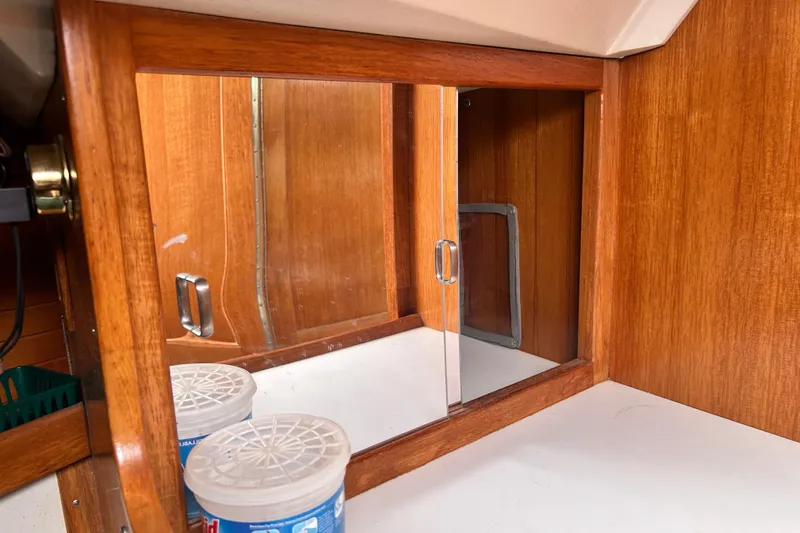 Slide: The Image of Wooden interior of 1998 Catalina 36 MkII sailboat with mirrored cabinet and storage containers. - 79