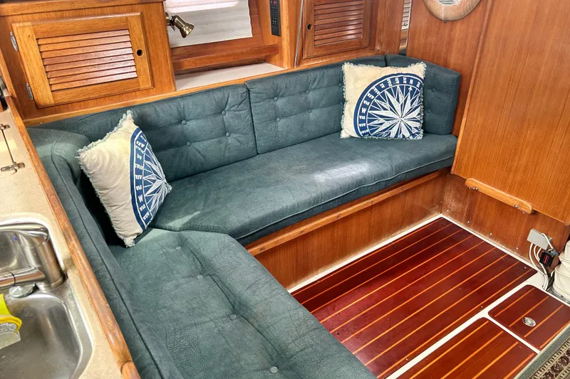 Slide: The Image of Cozy interior of 1998 Catalina 36 MkII sailboat with blue cushions and nautical decor. - 52