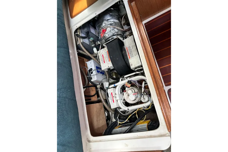 Slide: The Image of Engine compartment of a 1998 Catalina 36 MkII sailboat, showing mechanical components and wiring. - 50