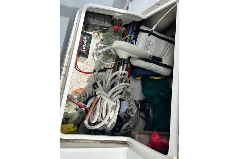 Slide: The Image of Storage compartment of a 1998 Catalina 36 MkII sailboat with ropes and equipment. - 19