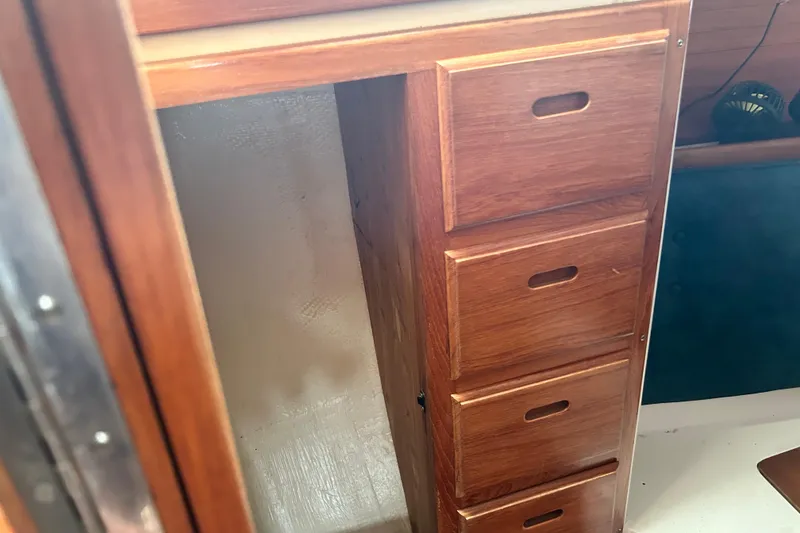 Slide: The Image of Wooden cabinetry inside a 1998 Catalina 36 MkII sailboat, featuring multiple drawers. - 48