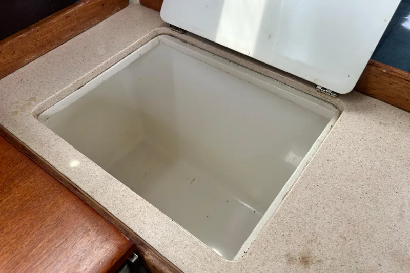 Slide: The Image of Open storage compartment on 1998 Catalina 36 MkII sailboat, featuring a clean, white interior. - 39