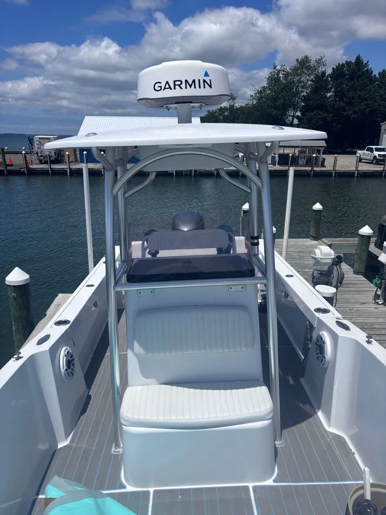 Slide: The Image of A 1993 Aquasport 2300 Center Console boat docked. It features a Garmin radar. - 2