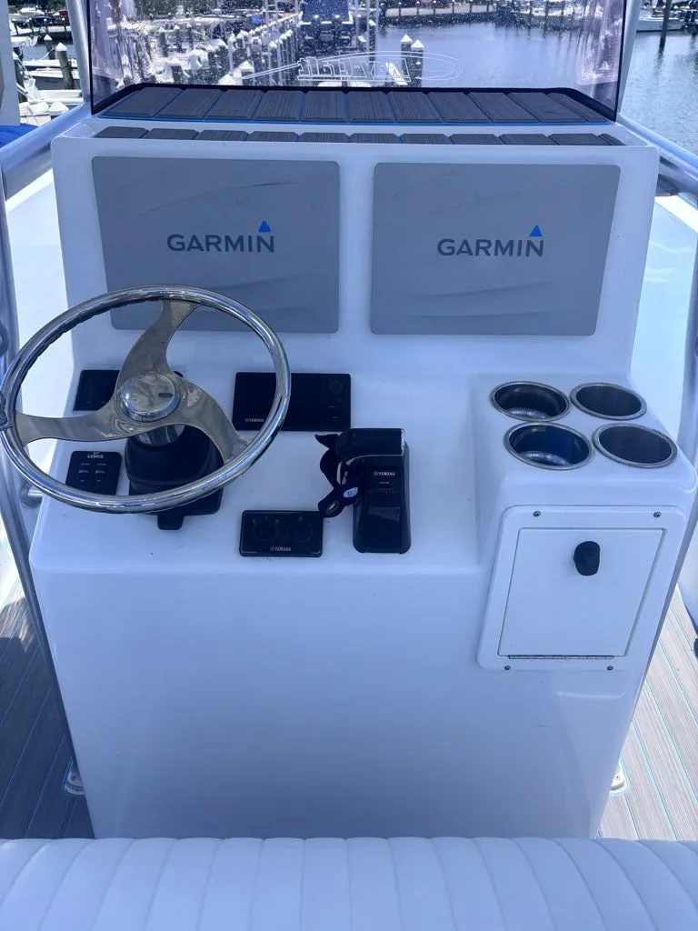 Slide: The Image of The image shows the helm of a 1993 Aquasport 2300 Center Console boat with Garmin devices. - 3