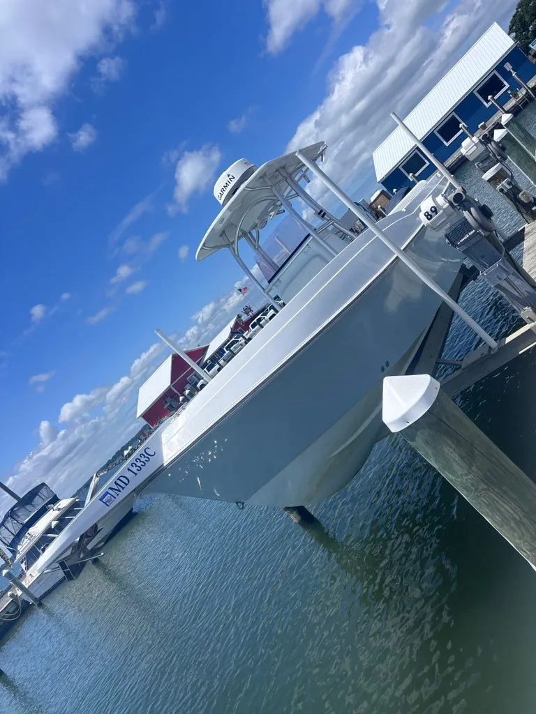 The Image of A 1993 Aquasport 2300 Center Console boat docked on the water. - 0
