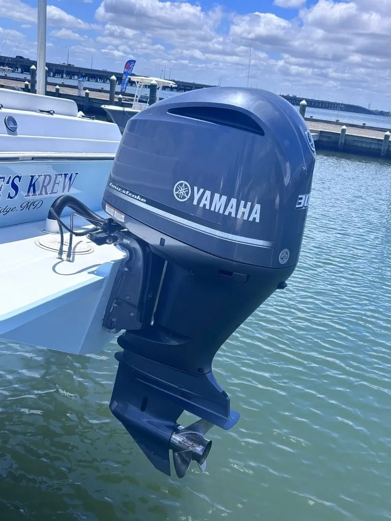 Slide: The Image of A Yamaha outboard motor is attached to a boat floating on the water. - 6