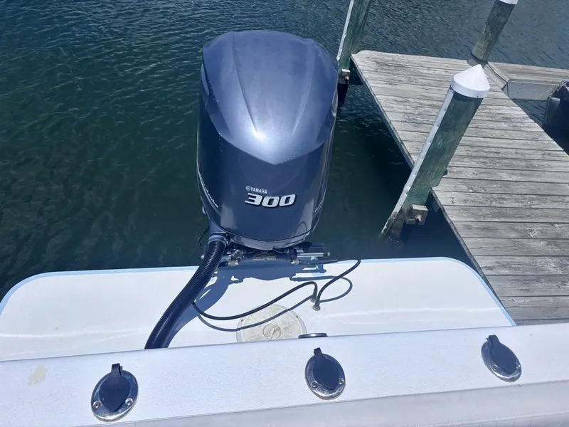 Slide: The Image of A boat with a Yamaha 300 outboard motor, docked at a wooden pier on the water. - 5