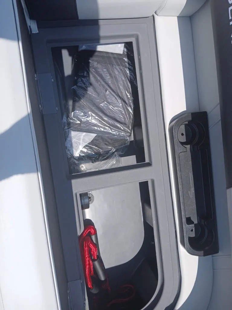 Slide: The Image of Interior view of a Bennington 20SL boat with storage compartment and cup holders. - 28