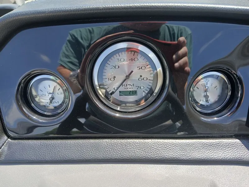 Slide: The Image of Close-up of a boat instrument panel with a tachometer and other gauges. - 5