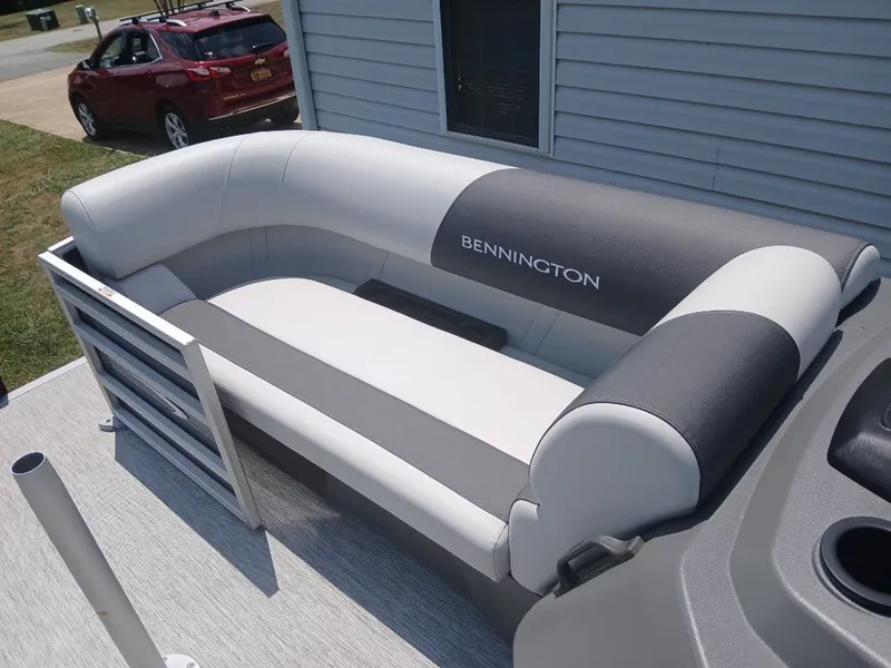 Slide: The Image of The image shows a gray and white bench seat on a Bennington boat. - 23