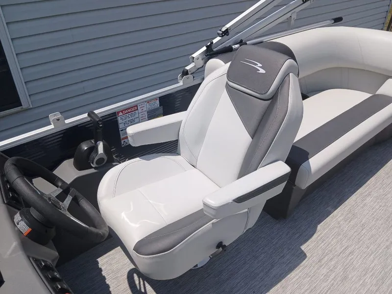 Slide: The Image of The image shows the interior of a Bennington 20SL boat with a cushioned captain's chair. - 11