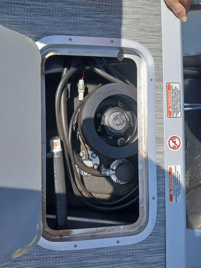 Slide: The Image of An open compartment on a boat reveals cables and mechanical parts. - 24