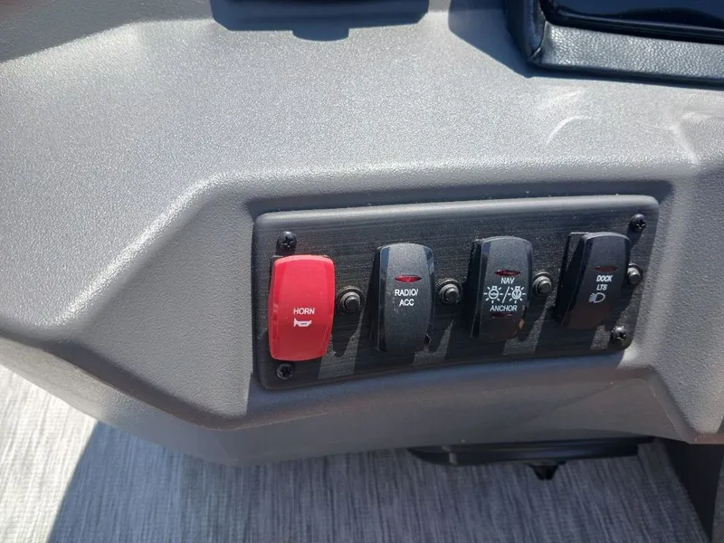 Slide: The Image of Close-up of a control panel with various switches, including a red horn button. - 9