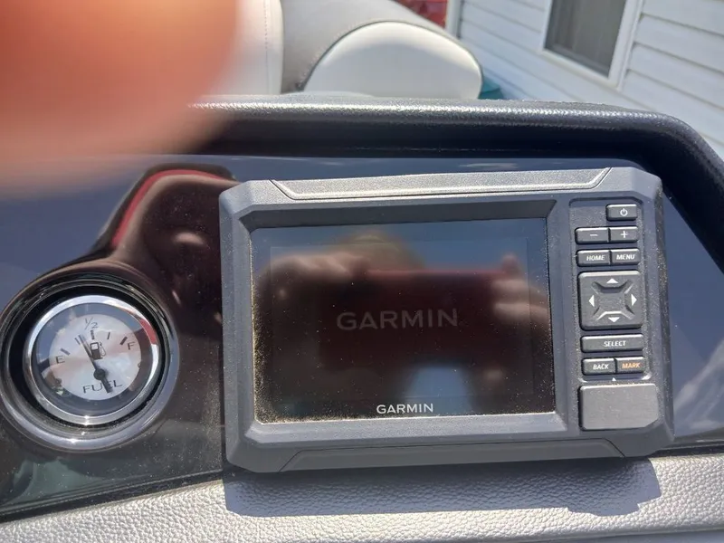 Slide: The Image of Garmin navigation system and fuel gauge on a boat. - 8