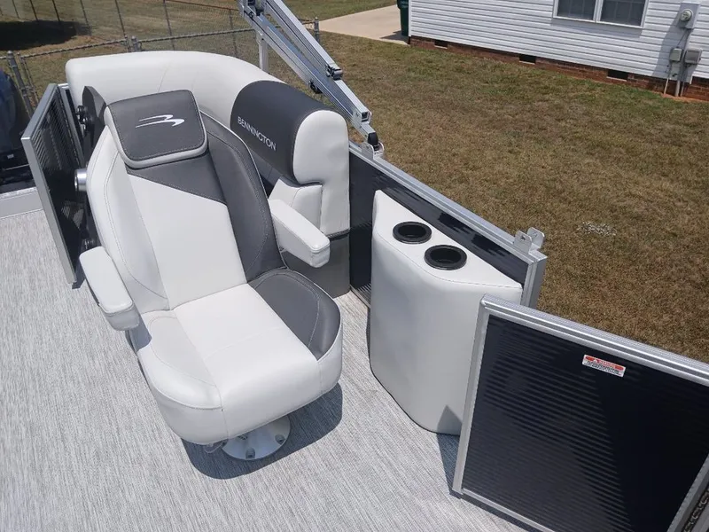 Slide: The Image of The image shows the seating area of a Bennington 20SL boat with white and gray upholstery. - 15