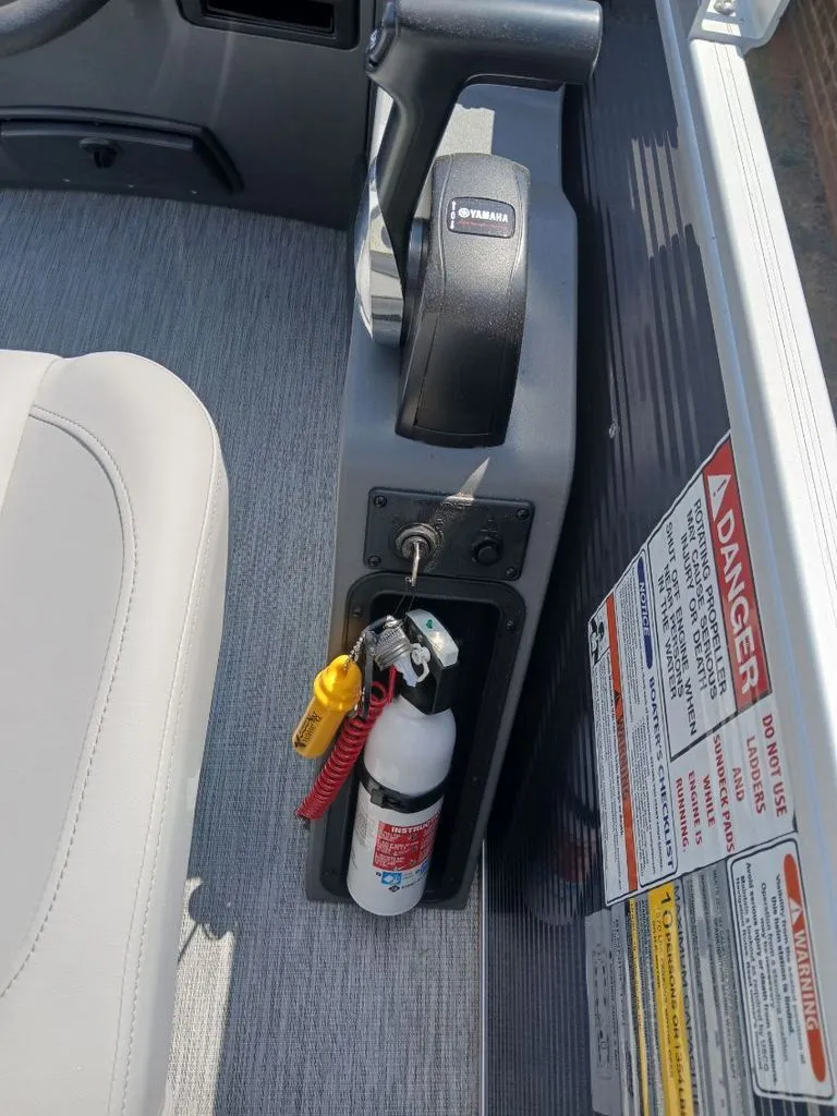 Slide: The Image of Close-up of a boat console with a fire extinguisher and Yamaha control. - 12