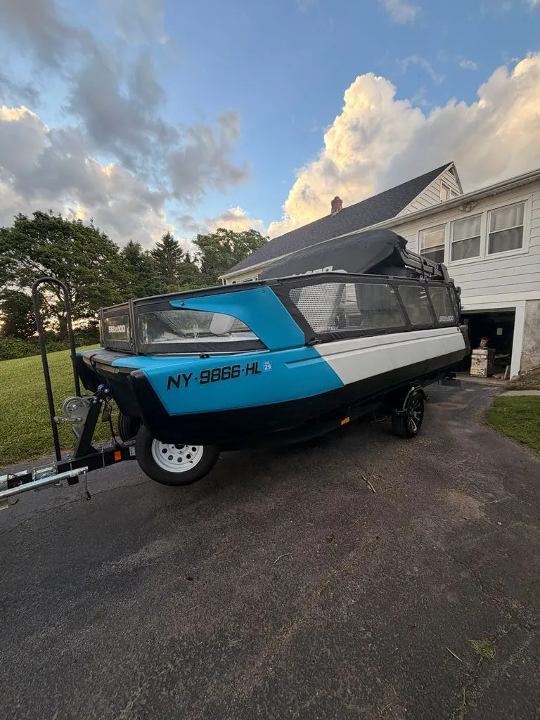 Slide: The Image of Sea-Doo Switch Sport 2023 on a trailer in front of a house. - 2