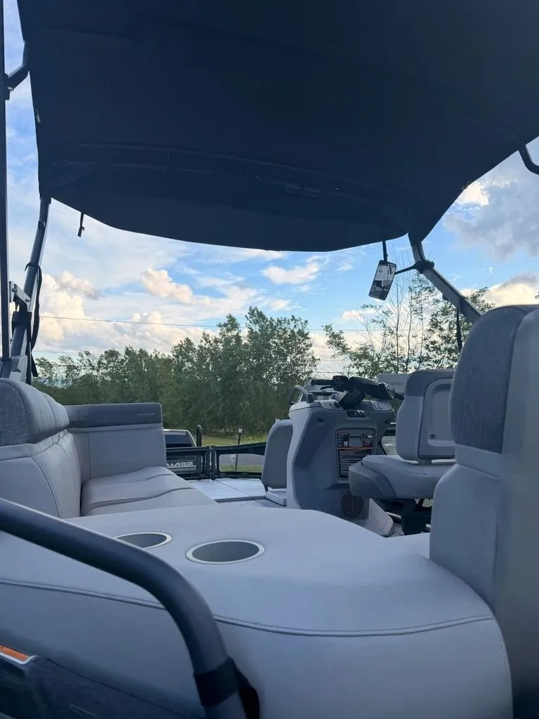 Slide: The Image of Interior view of a 2023 Sea-Doo Switch Sport with gray seating and a black sunshade. - 13