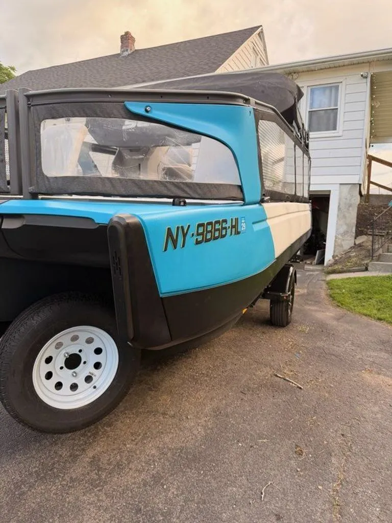Slide: The Image of A blue and white 2023 Sea-Doo Switch Sport on a trailer in front of a house. - 17
