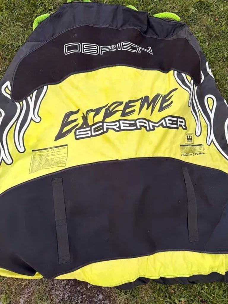 Slide: The Image of Inflatable water sports tube with "Extreme Screamer" text on grass. - 8