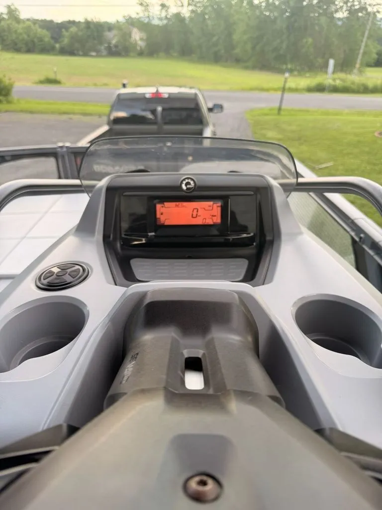 Slide: The Image of The dashboard of a 2023 Sea-Doo Switch Sport with a digital display and cup holders. - 7
