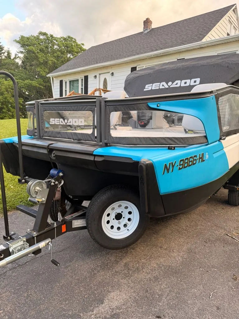 Slide: The Image of A 2023 Sea-Doo Switch Sport on a trailer in front of a house. - 10