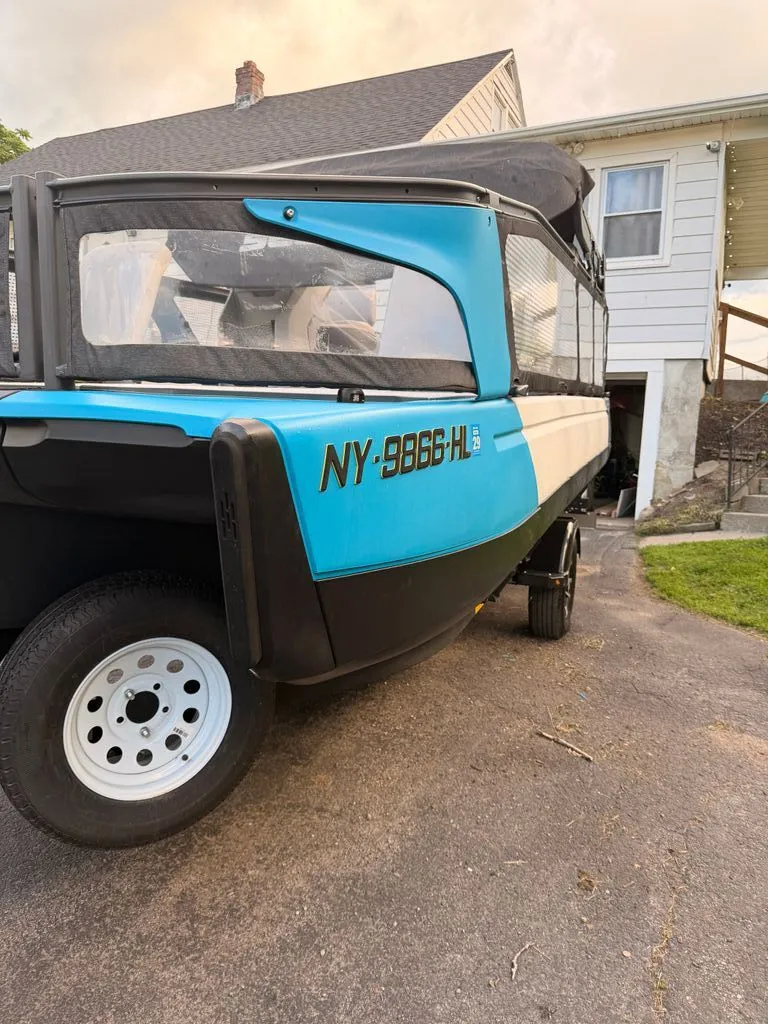 Slide: The Image of A blue and black 2023 Sea-Doo Switch Sport on a trailer in front of a house. - 19