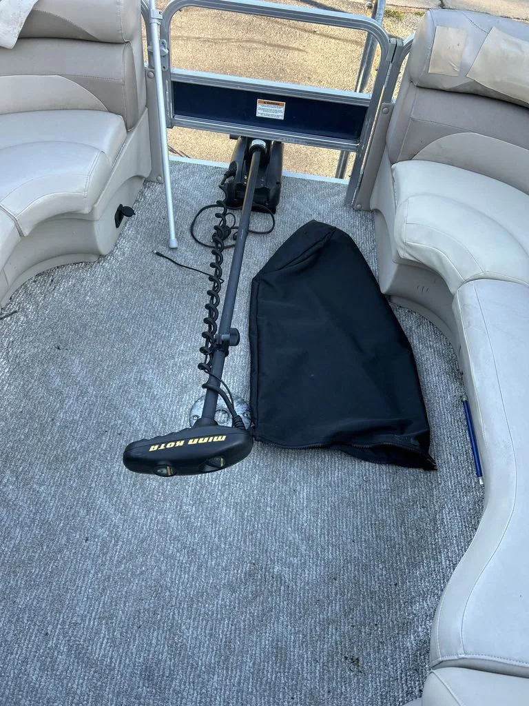 Slide: The Image of Interior of a 2011 Sylvan 8520 Cruise pontoon boat with carpeted floor and seating. - 16