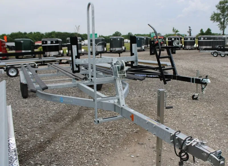 Slide: The Image of An empty boat trailer sits on a gravel lot, surrounded by other trailers. - 27