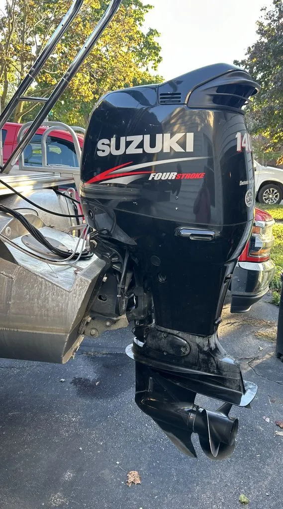 Slide: The Image of A Suzuki outboard motor is attached to a boat on a trailer. - 17