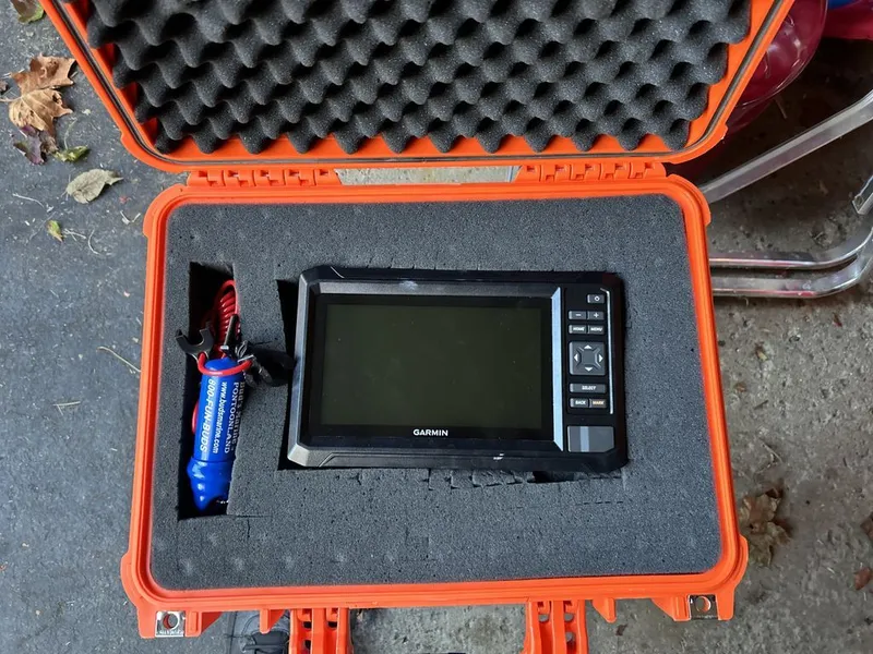 Slide: The Image of A Garmin device in an orange protective case with foam padding. - 15