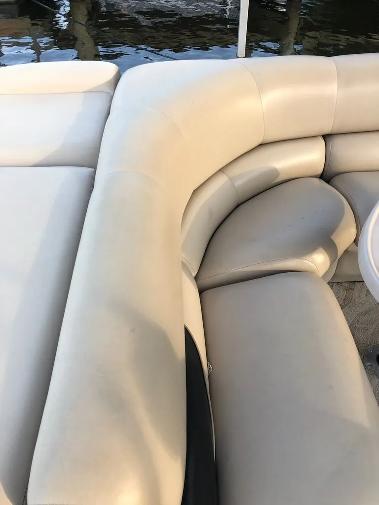Slide: The Image of Beige cushioned seating on a boat, with water in the background. - 9