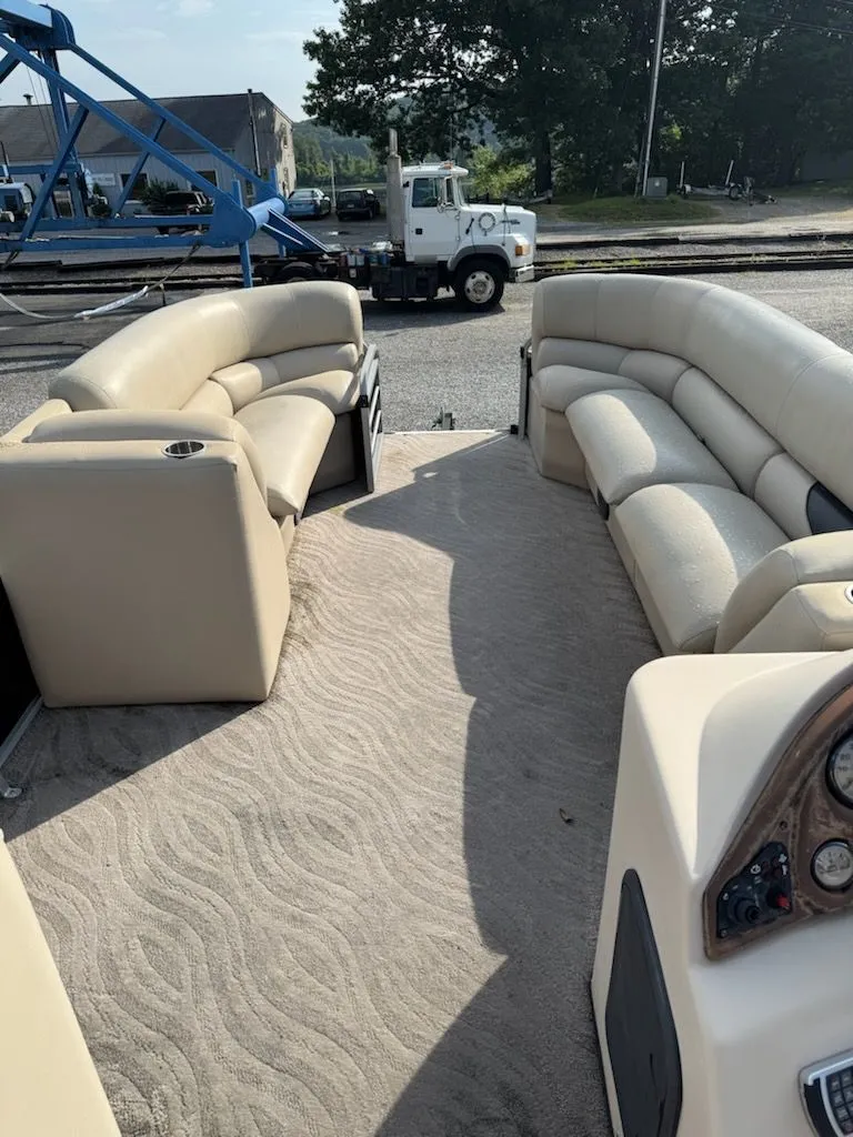 Slide: The Image of Interior view of a 2014 Bentley Pontoons Elite 25 with beige seating. - 7