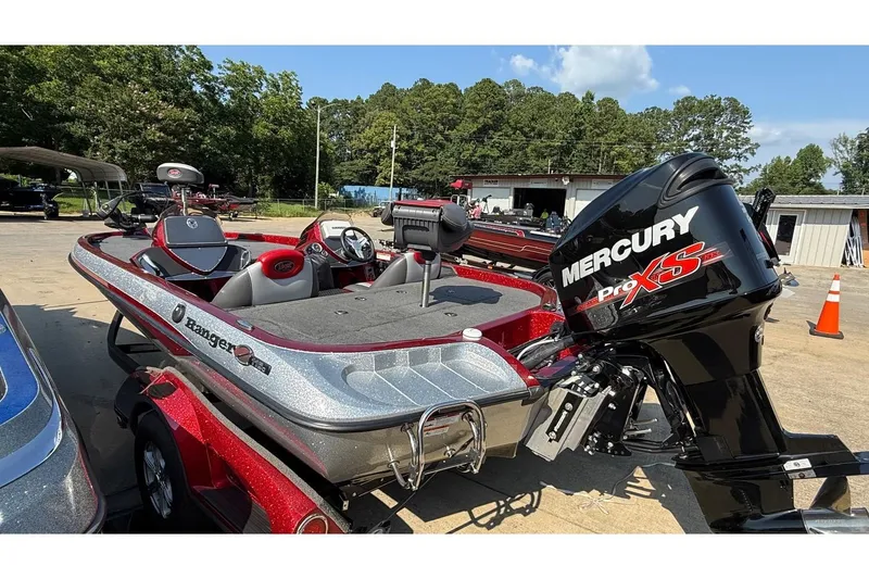 Slide: The Image of 2014 Ranger Z118 Comanche boat with Mercury Pro XS engine, parked outdoors. - 11