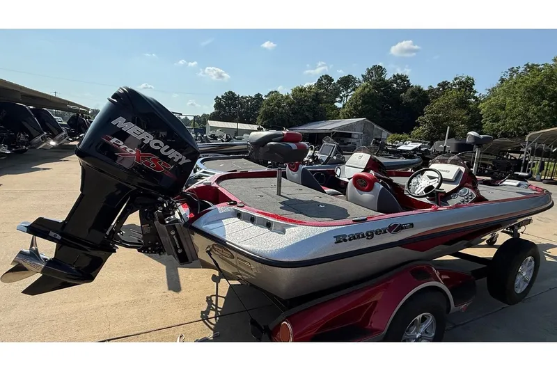Slide: The Image of 2014 Ranger Z118 Comanche boat with Mercury Pro XS engine, parked outdoors. - 10