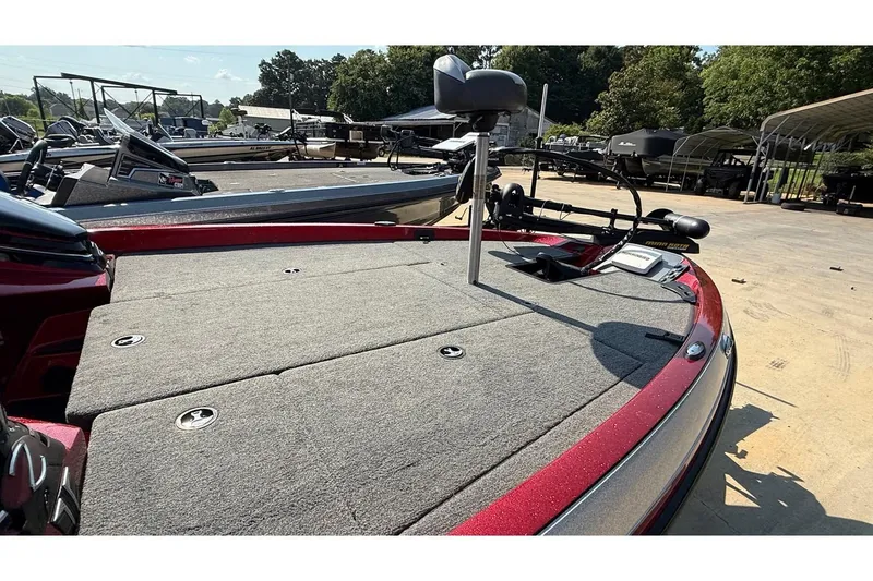 Slide: The Image of 2014 Ranger Z118 Comanche boat deck with seating and control panel in a marina setting. - 13