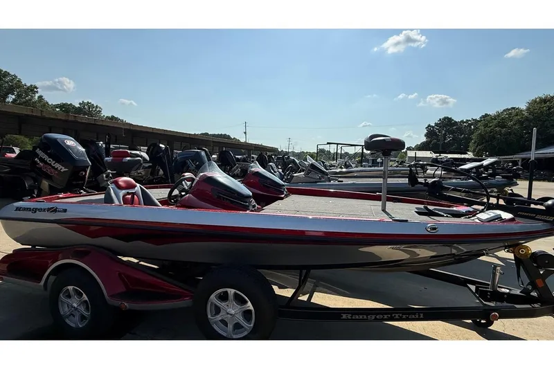 Slide: The Image of 2014 Ranger Z118 Comanche bass boat on trailer in outdoor lot. - 8