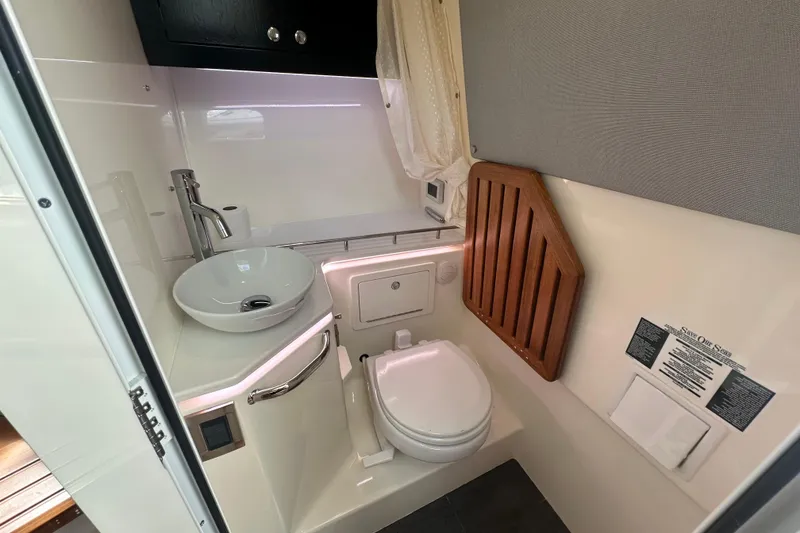 Slide: The Image of 2024 Boston Whaler 380 Realm bathroom with modern sink and toilet. - 19