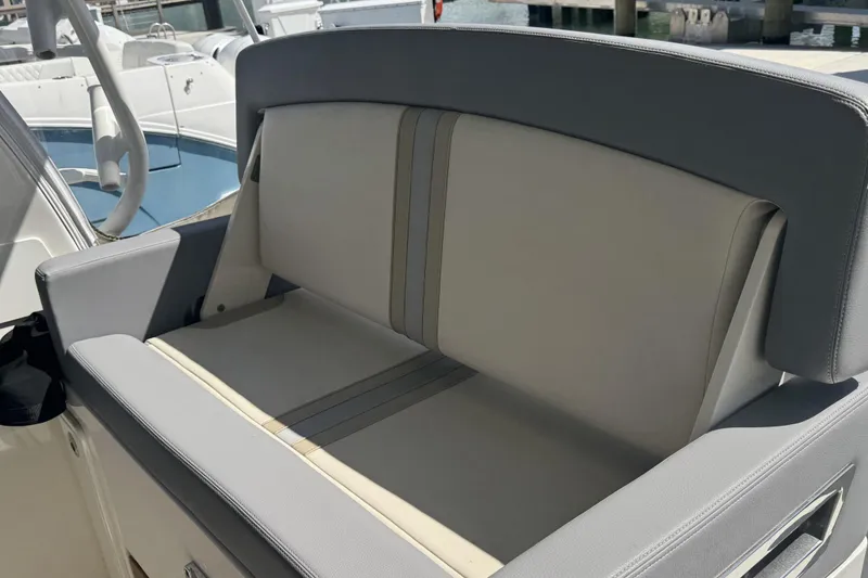 Slide: The Image of 2024 Boston Whaler 380 Realm boat seating, featuring sleek gray and white upholstery. - 9