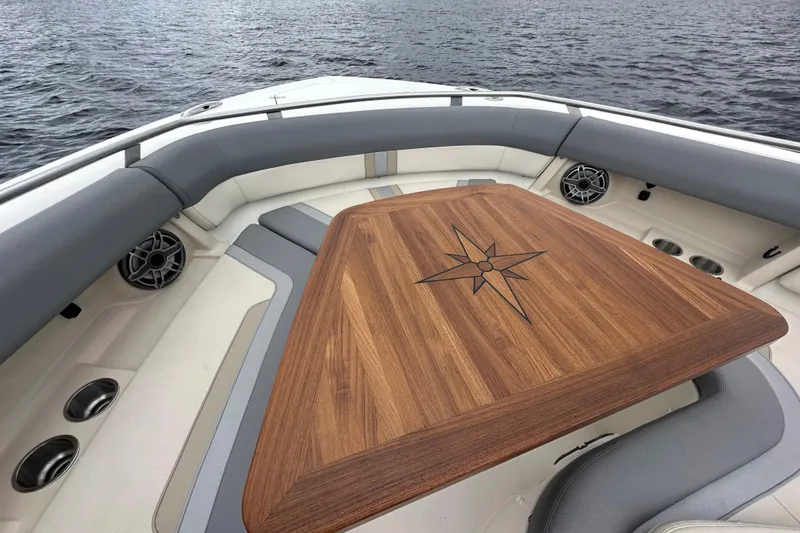 Slide: The Image of Luxurious 2024 Boston Whaler 380 Realm boat interior with elegant wooden table design. - 14
