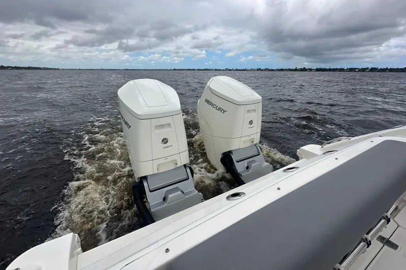 Slide: The Image of Boston Whaler 380 Realm 2024 with dual Mercury outboard engines on open water. - 3