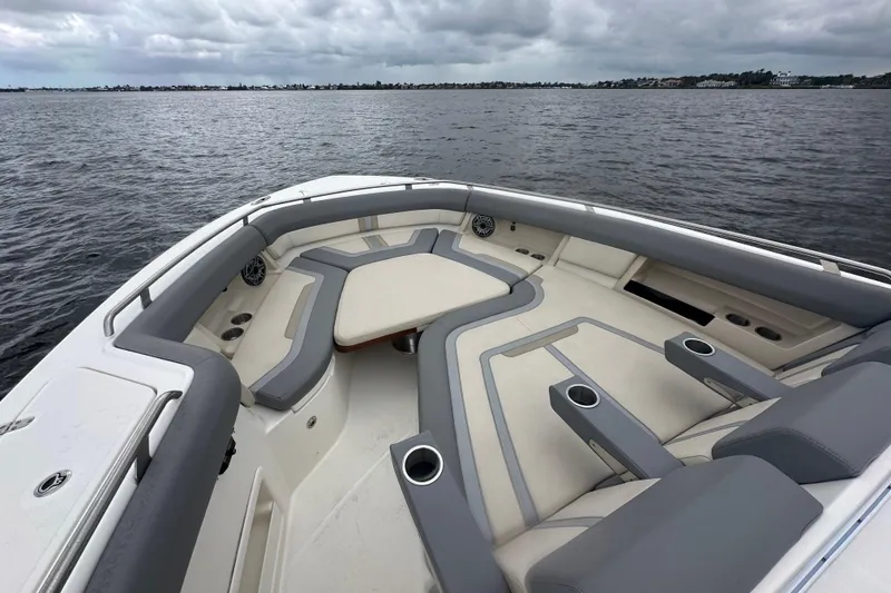 Slide: The Image of Luxurious seating on 2024 Boston Whaler 380 Realm boat, overlooking calm waters. - 15
