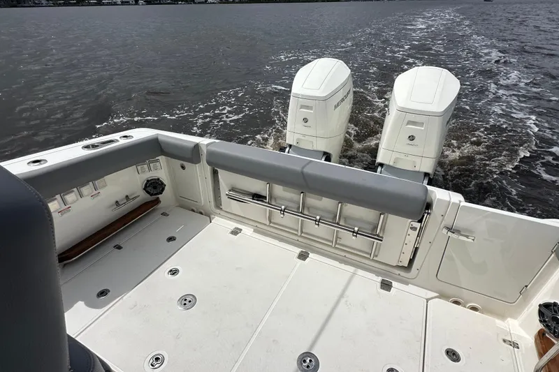 Slide: The Image of 2024 Boston Whaler 380 Realm boat deck with dual Mercury outboard engines on water. - 5