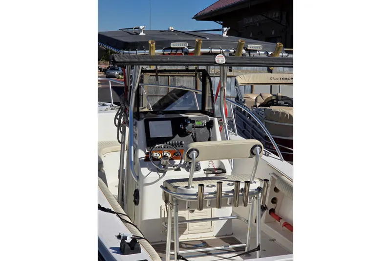 Slide: The Image of 2006 Mako 252 Center Console boat with steering wheel and fishing rod holders. - 9